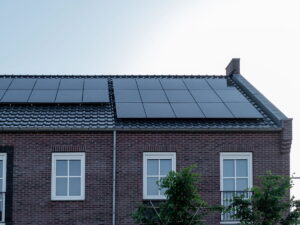 Newly build houses with solar panels attached on the roof against a sunny sky